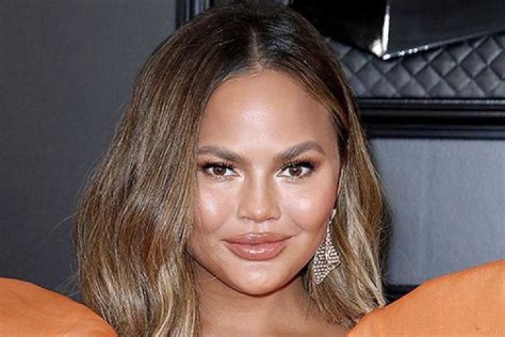 Chrissy Teigen Reveals Scars After Having Breast Implants Removed Last Year — Watch
