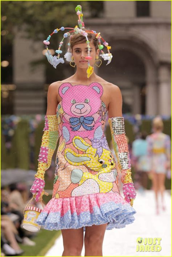 New Mom Gigi Hadid Slays In Colorful Crop Top & Skirt As She Holds Baby Bottle On Moschino Runway