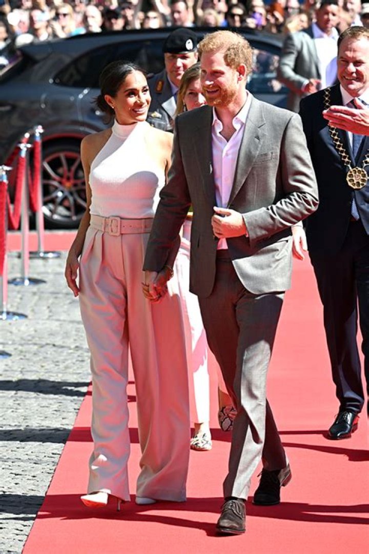 Prince Harry & Meghan Markle Hold Hands As They Arrive At Germany Event